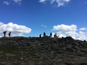 The rocky summit of Mt Moosilauke, with hikers silhouetted against the sky. Deborah Lee Luskin, photo