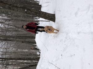 Emissions Equation: man and dog in winter woods