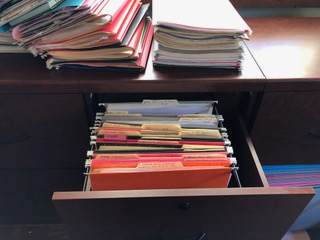 A wooden file drawer with orderly filed papers. Deborah Lee Luskin photo.