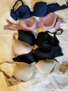 pink, black and beige bras in a tangle.